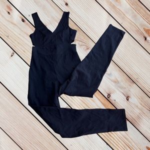 Rolla Coster form fitting black jumpsuit with side cutouts and gold zipper back